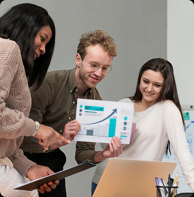 Team reviewing business charts and documents in an office